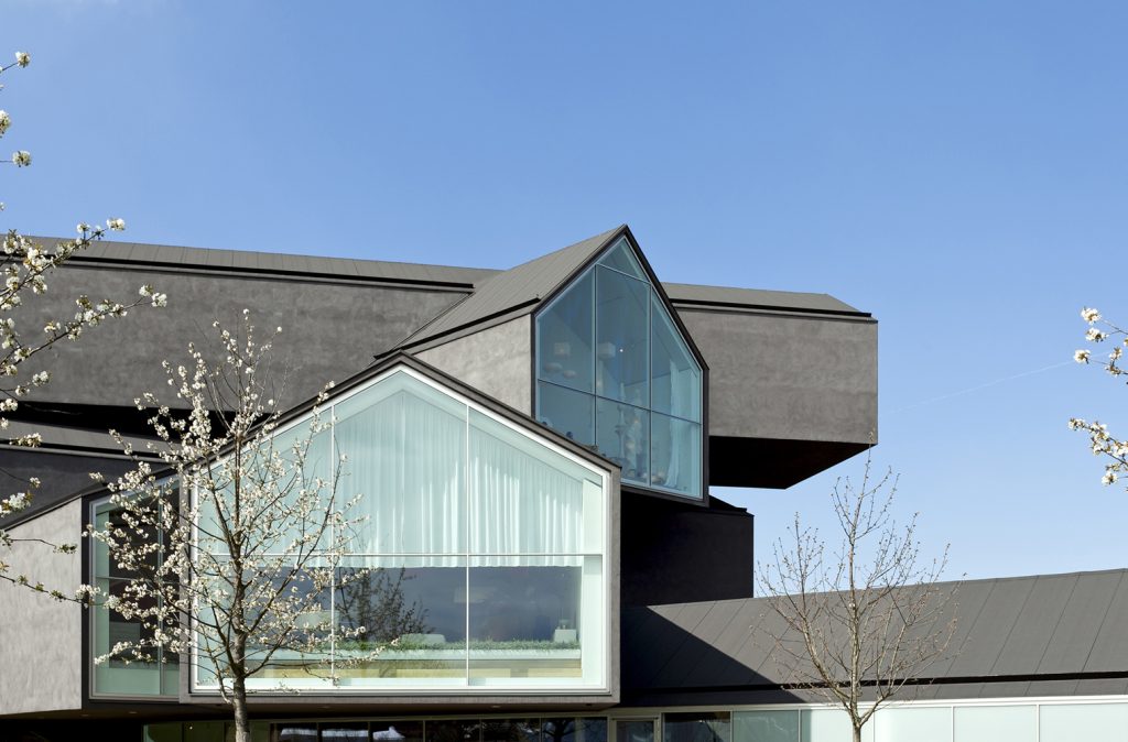 Vitra House & Campus - Herzog & De Meuron - Modern black building with big windows under a clear sky
