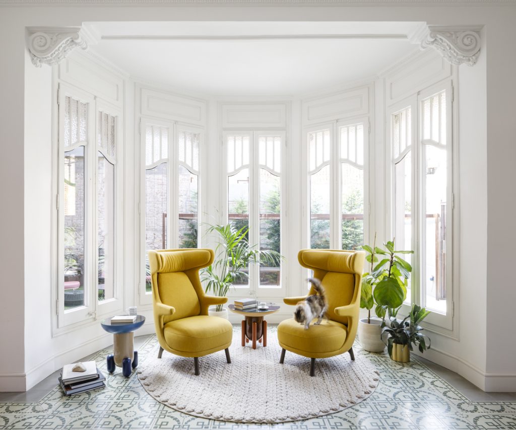 Dino Armchair, Table Explorer, and Showtime Chair - Jaime Hayón for BD Barcelona Design - Modern yellow armchairs next to large windows and a cat