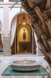 Dar Al Dall - StaythisTime Tomorrow - Ornate Moroccan courtyard with a fountain, traditional architecture, and intricate tile work